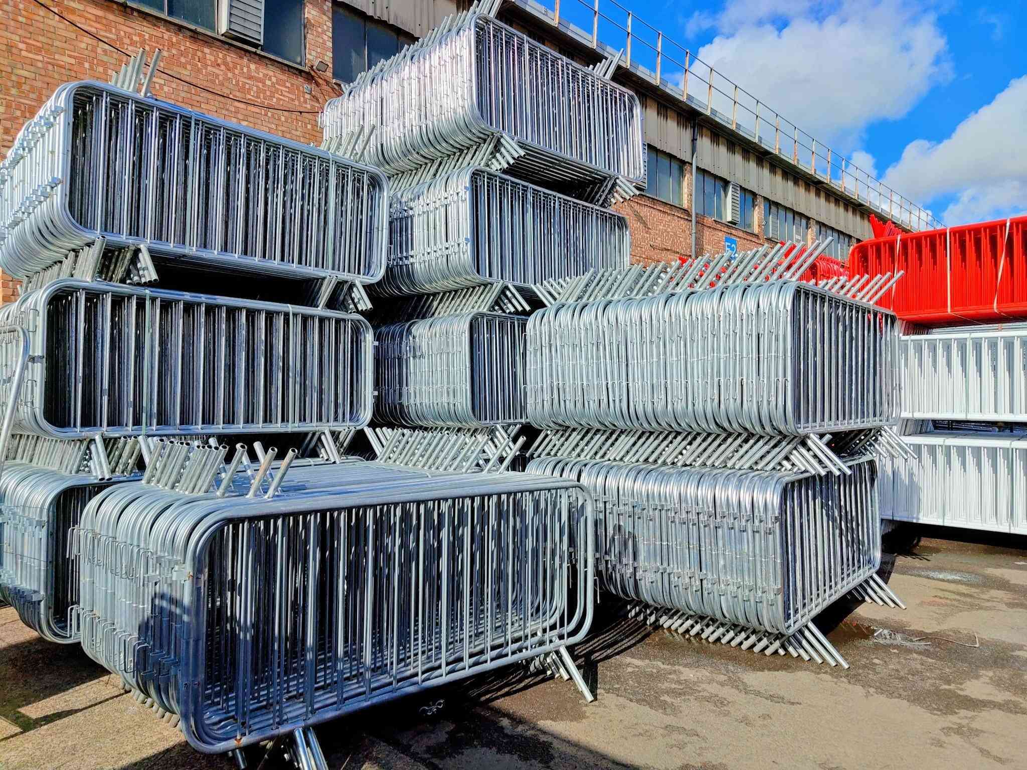 Galvanised crowd control barriers stacked ready for installation — Tempfence UK