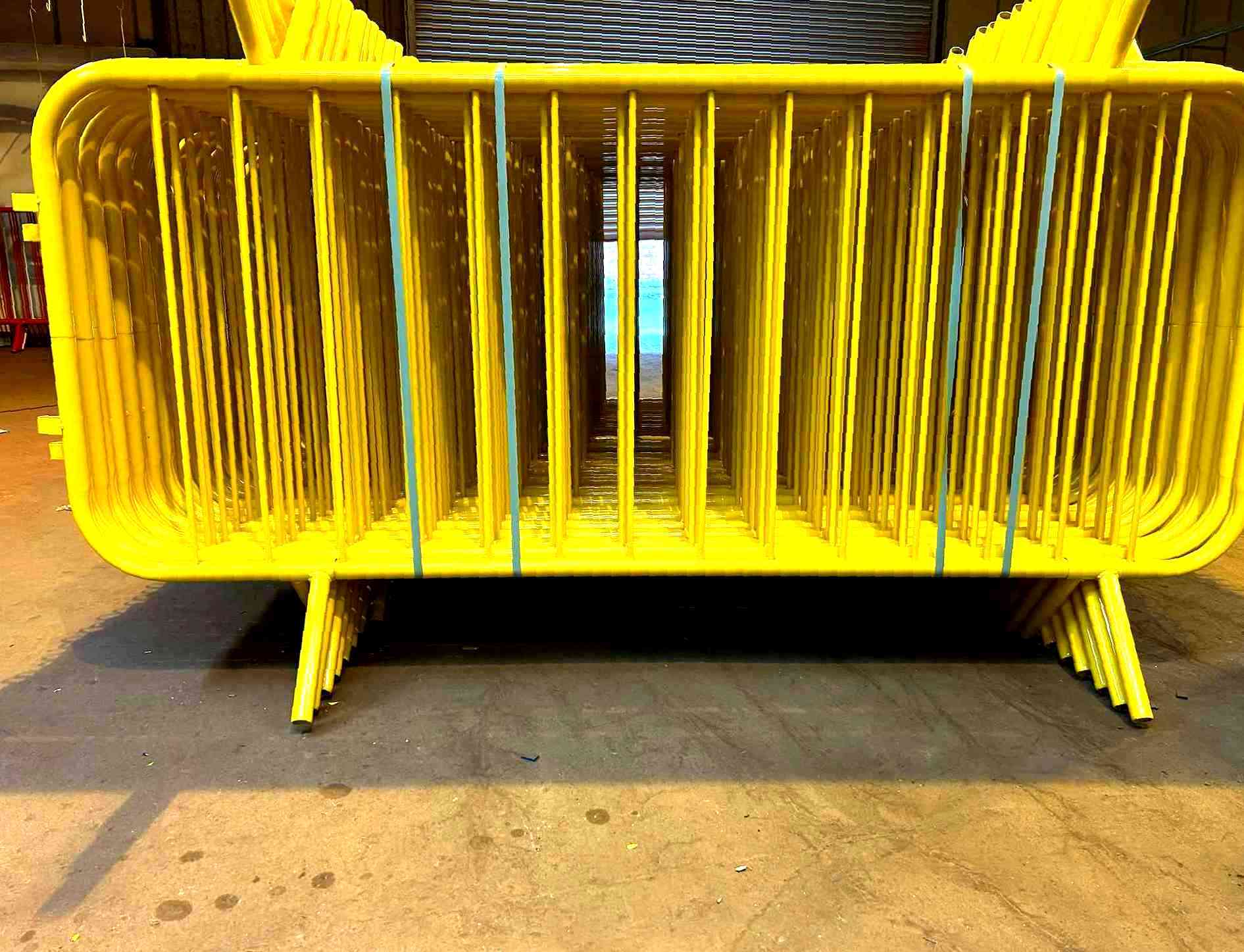 Powder-coated yellow crowd control barriers — Tempfence UK
